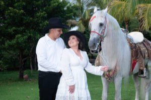 Pareja posando junto a un caballo blanco