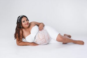 Retrato de maternidad con vestido blanco en estudio