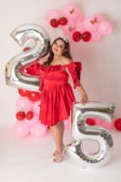 Sesión de cumpleaños con vestido rojo y globos de números
